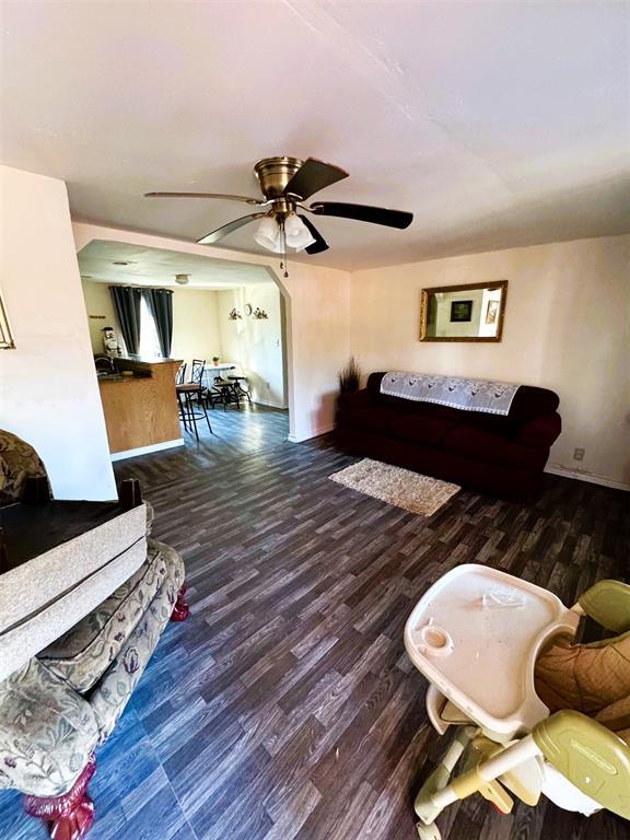 living room featuring ceiling fan and hardwood / wood-style flooring