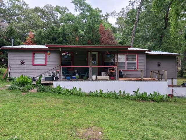 back of property featuring a lawn