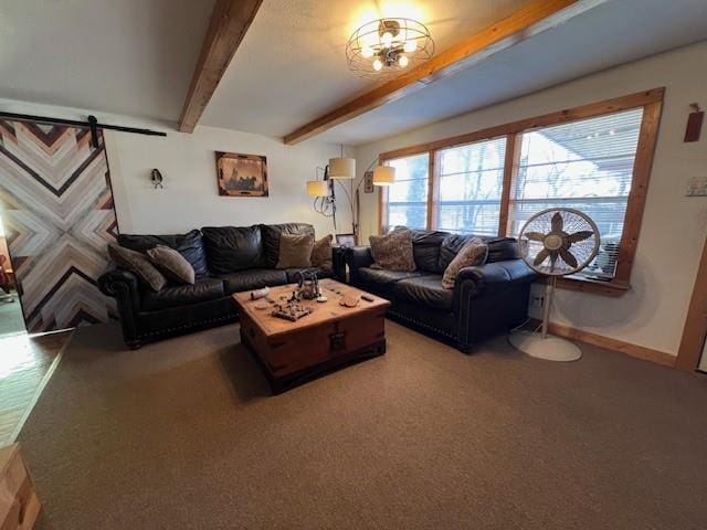 living room featuring beamed ceiling and a barn door