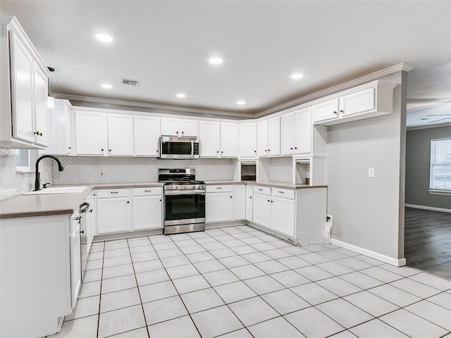 kitchen with white cabinetry, sink, crown molding, and appliances with stainless steel finishes