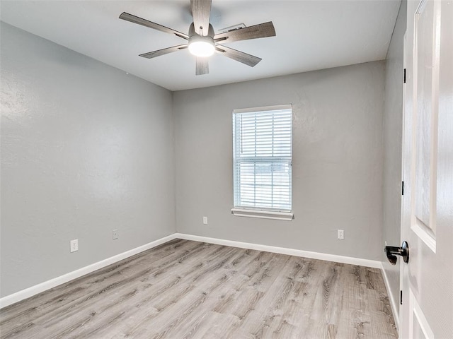 empty room with ceiling fan and light hardwood / wood-style floors