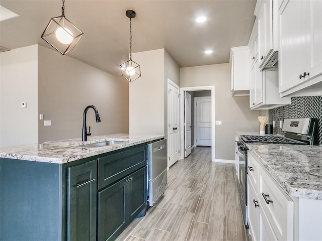 kitchen featuring white cabinets, pendant lighting, stainless steel appliances, and light stone counters