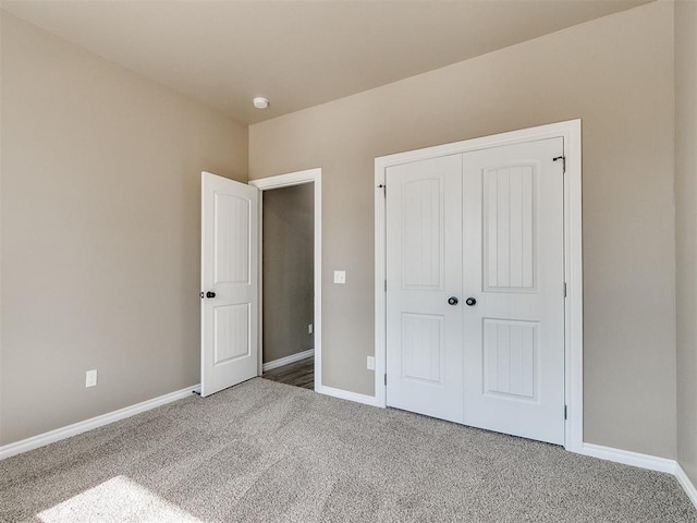 unfurnished bedroom with carpet and a closet