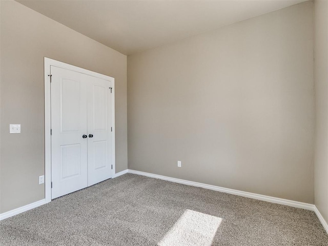 unfurnished bedroom featuring carpet and a closet