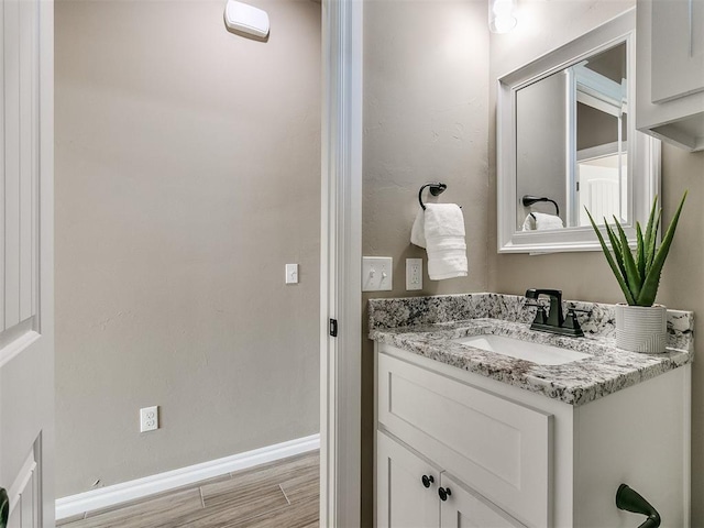 bathroom featuring vanity and hardwood / wood-style flooring