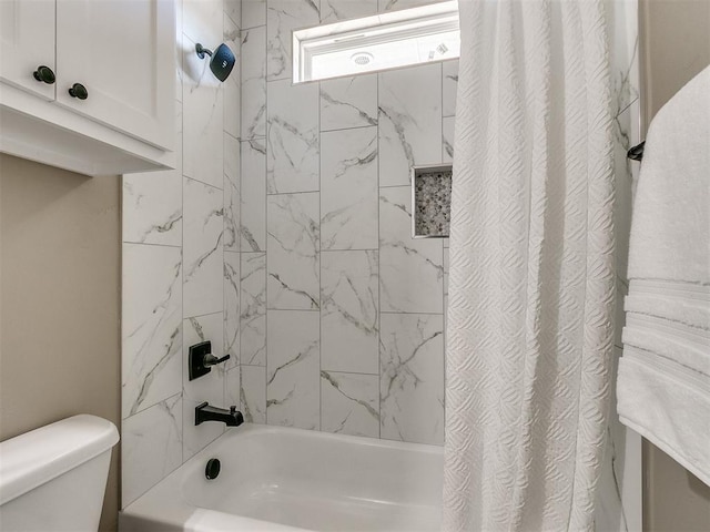 bathroom featuring toilet and shower / tub combo with curtain