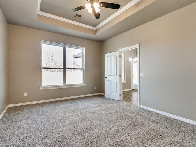 unfurnished room featuring carpet flooring, a raised ceiling, ceiling fan, and crown molding