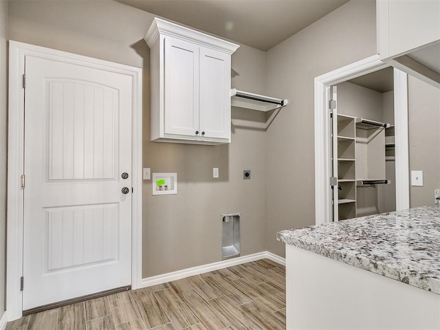 laundry room featuring hookup for a washing machine, cabinets, and hookup for an electric dryer