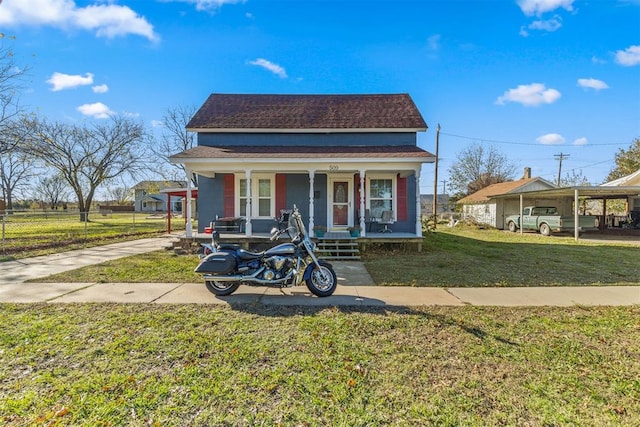 bungalow-style home with a front lawn, covered porch, and a carport