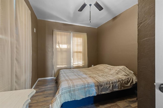 bedroom featuring ceiling fan and dark wood-type flooring