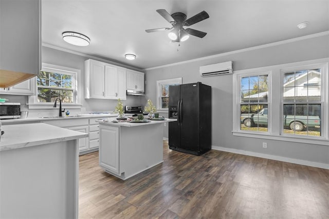 kitchen with a center island, white cabinetry, sink, and appliances with stainless steel finishes