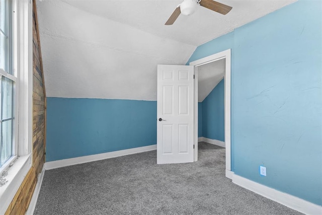 additional living space with carpet floors, ceiling fan, and lofted ceiling