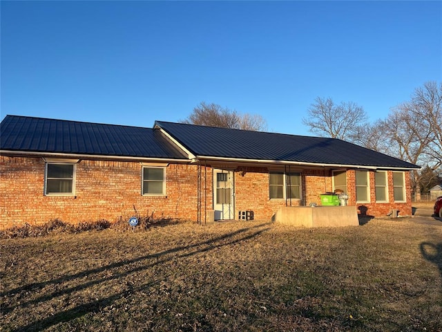 rear view of house featuring a yard