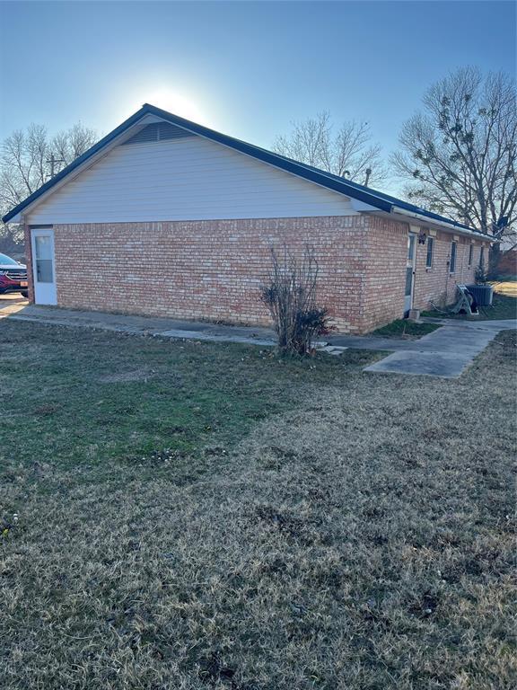 view of property exterior featuring a yard and a patio area