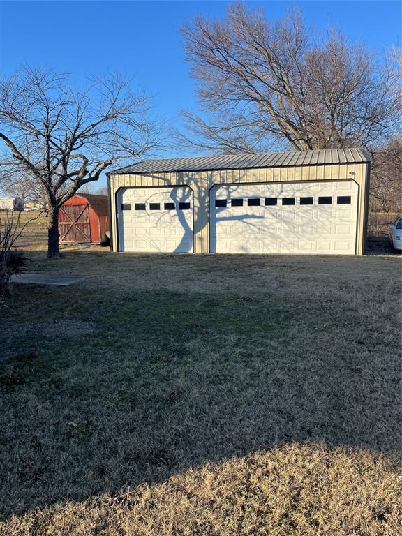 garage with a yard