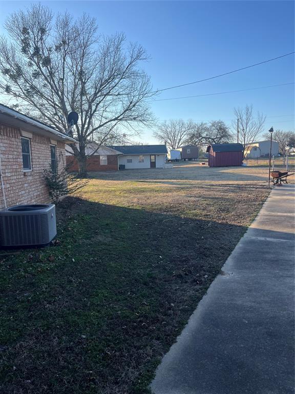 view of yard featuring central air condition unit