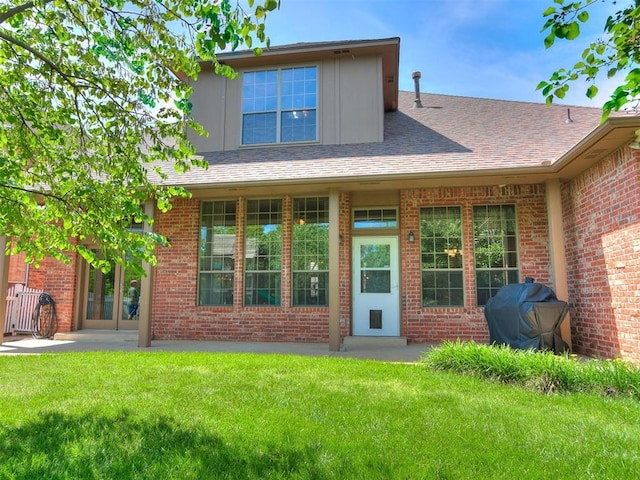 rear view of house with a yard