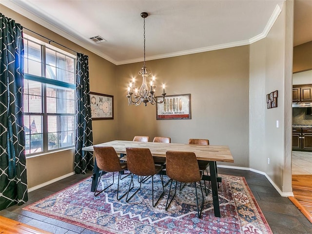 dining space with dark wood-type flooring, ornamental molding, and an inviting chandelier