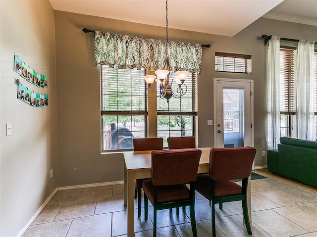 tiled dining area with a notable chandelier and crown molding