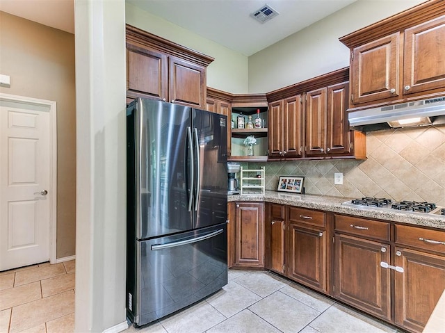 kitchen with tasteful backsplash, light tile patterned floors, and stainless steel appliances