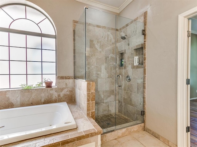 bathroom with tile patterned floors, shower with separate bathtub, and ornamental molding