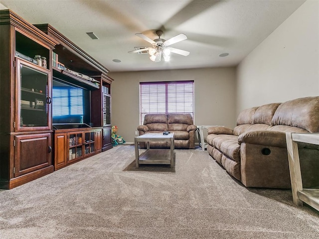 living room featuring carpet flooring and ceiling fan