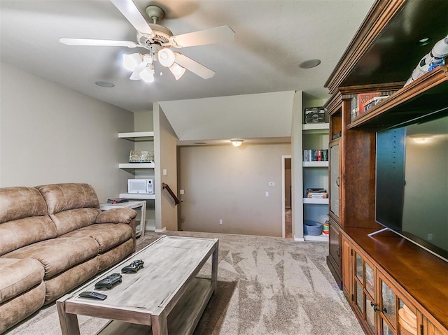 living room with ceiling fan and carpet floors