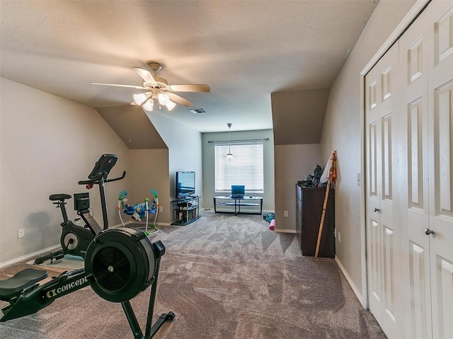 workout area featuring ceiling fan, carpet, and lofted ceiling