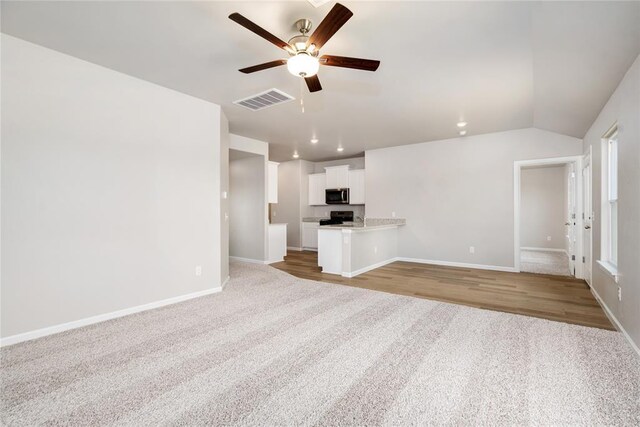5435 Mac Rd, Tuttle, OK 73089 - unfurnished living room with light carpet, vaulted ceiling, and ceiling fan