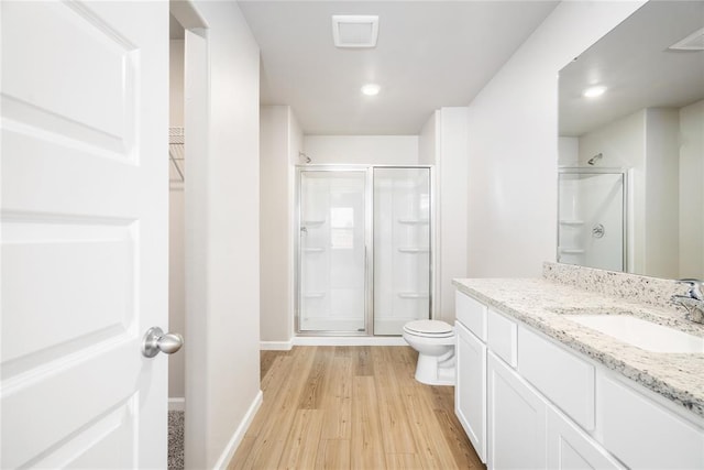 5435 Mac Rd, Tuttle, OK 73089 - bathroom with wood-type flooring, vanity, toilet, and walk in shower