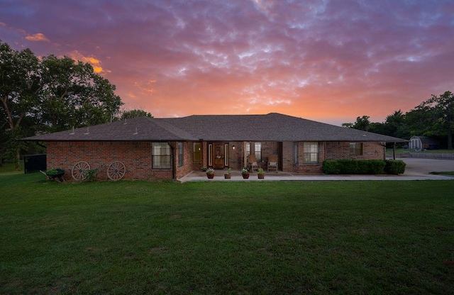 view of front of property featuring a yard and a patio