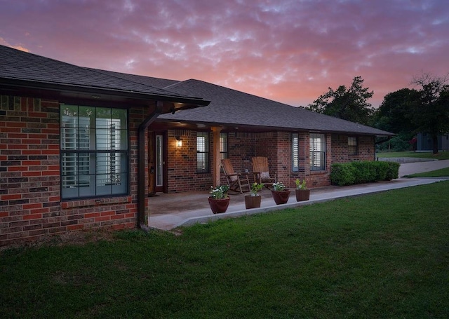 back house at dusk with a yard