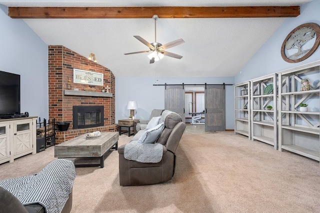 living room with ceiling fan, a barn door, carpet floors, and lofted ceiling