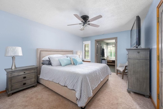 carpeted bedroom with ceiling fan and a textured ceiling