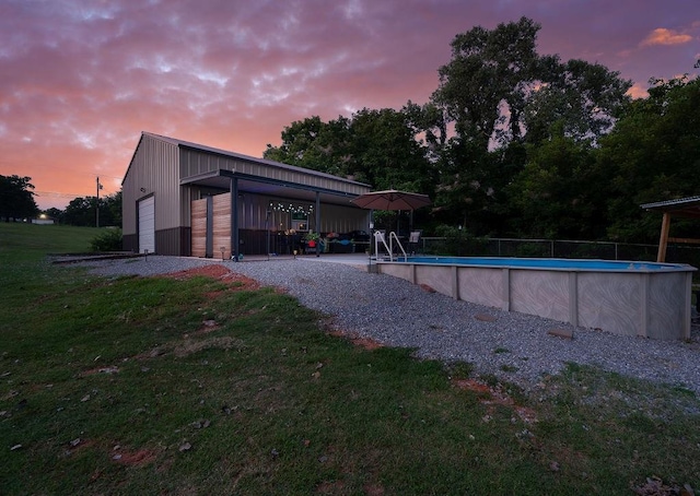 pool at dusk with a lawn