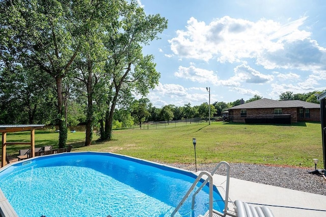 view of pool with a lawn