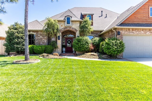 view of front of house with a garage and a front lawn