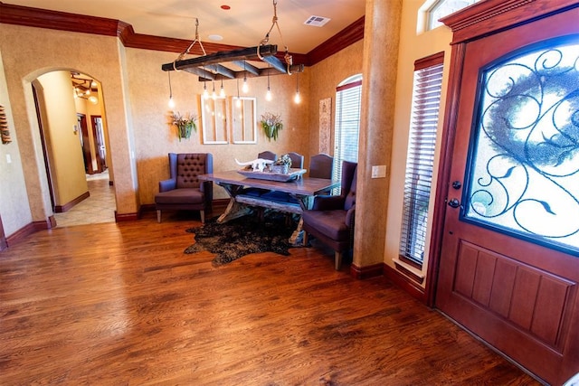 entrance foyer with wood-type flooring and ornamental molding