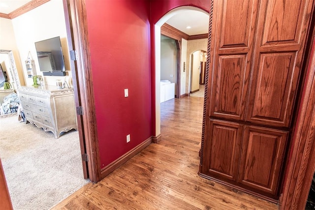 hall featuring hardwood / wood-style floors and crown molding