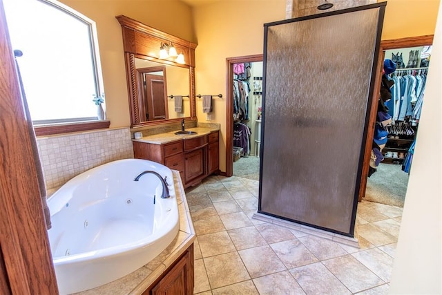 bathroom with shower with separate bathtub, vanity, and tile patterned floors