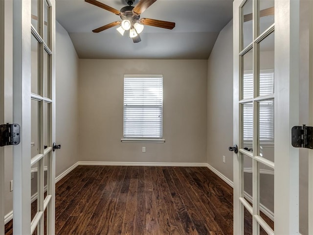 unfurnished room featuring ceiling fan, dark hardwood / wood-style flooring, lofted ceiling, and french doors