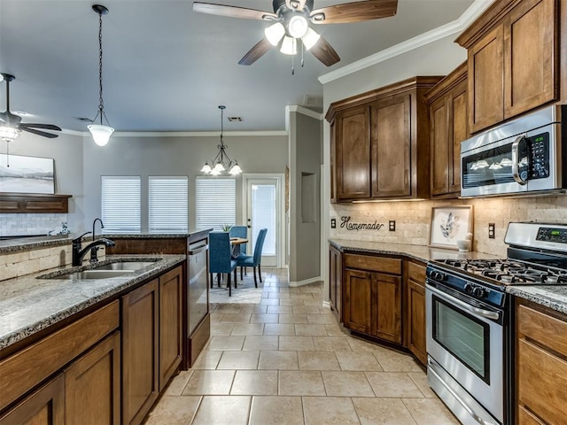 kitchen with sink, backsplash, pendant lighting, appliances with stainless steel finishes, and ornamental molding