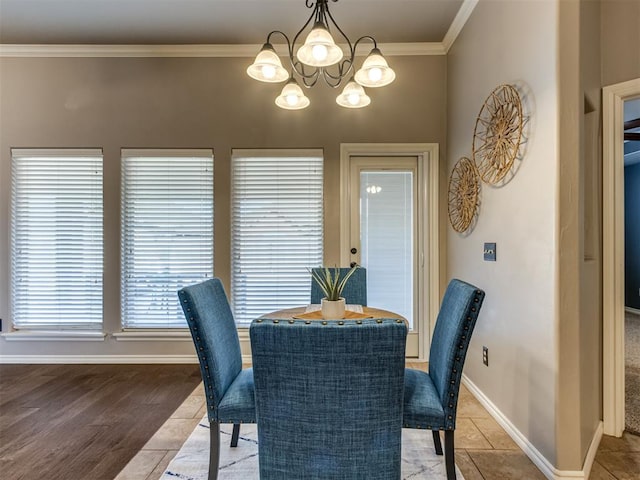 dining room featuring a chandelier, light tile patterned floors, and ornamental molding