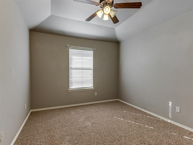 empty room with carpet, ceiling fan, and vaulted ceiling