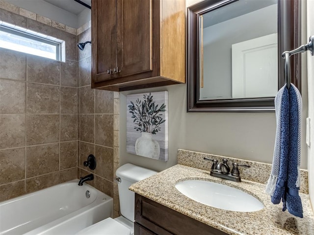 full bathroom with toilet, vanity, and tiled shower / bath combo