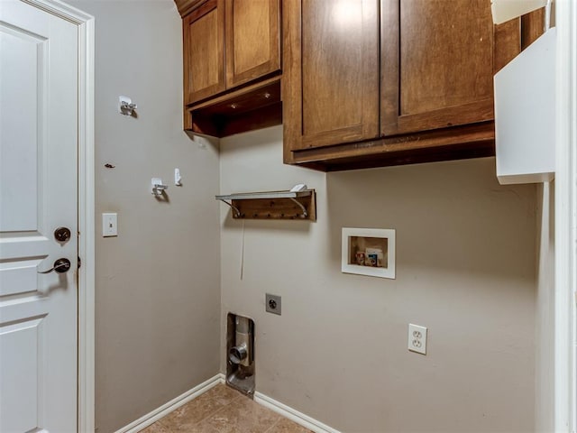 clothes washing area featuring electric dryer hookup, cabinets, and washer hookup