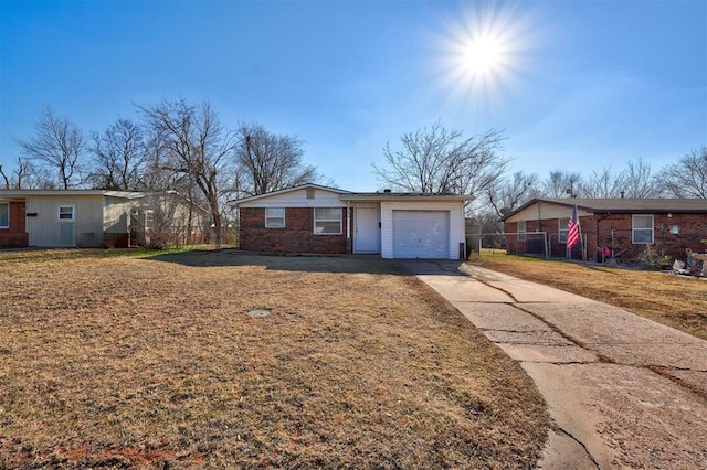 single story home with a garage and a front yard