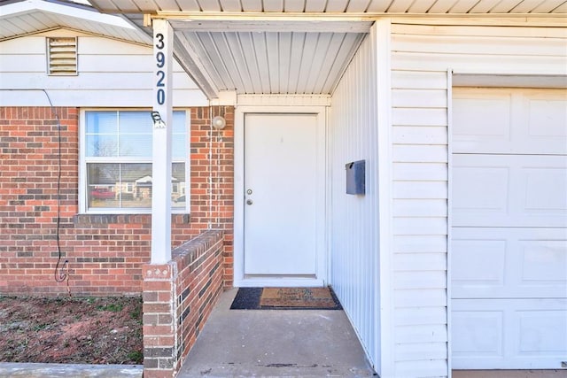 doorway to property with a garage