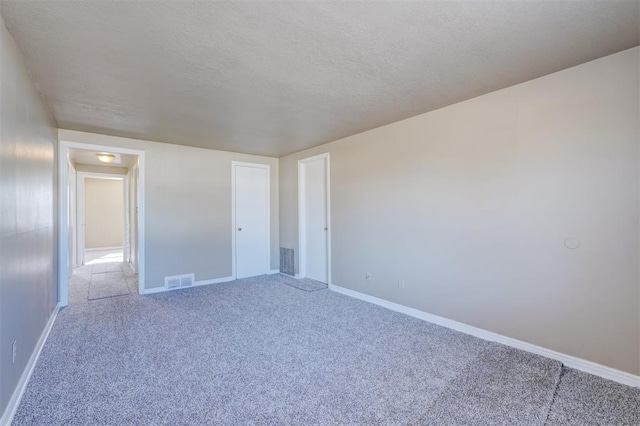 unfurnished bedroom with a closet, carpet floors, and a textured ceiling