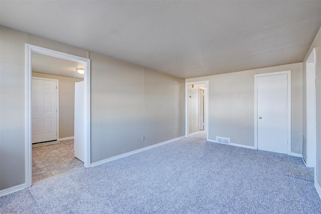 unfurnished bedroom featuring light carpet